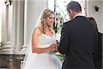 Bride and Groom exchanging vows and rings at Wedding ceremony, Canada