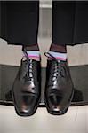 Close-up of men's dress shoes with striped socks, Canada