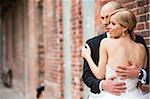 Close-up portrait of Bride and Groom embracing outdoors on Wedding Day, Canada