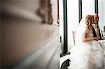 Bride and Groom sitting together indoors on Wedding Day, Canada