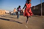 Girls playing hopscotch on street