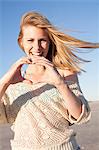 Smiling woman making heart sign with hands, Breezy Point, Queens, New York, USA