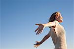 Smiling woman enjoying beach, Breezy Point, Queens, New York, USA