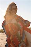 Young woman wrapped in blanket, Breezy Point, Queens, New York, USA