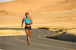 Young woman running on road, Bainbridge Island, Washington State, USA