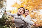 Father and Son Playing at Park in Autumn