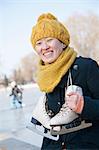 Young Woman Sitting with Ice Skates