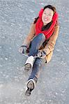 Young Woman Tying Ice Skates Outside