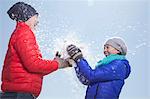 Two Young People Playing With Snow