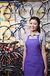 Portrait of young female mechanic in bicycle store, Beijing