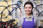 Portrait of young female mechanic in bicycle store, Beijing