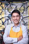 Portrait of young male mechanic in bicycle store, Beijing