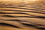 Surface level shot of the desert and the wind pattern on the sand