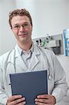 Portrait of smiling doctor holding a clipboard