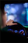 Over the shoulder view of businessman driving at night in the city