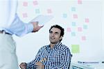 Two businessmen sitting and talking in the office