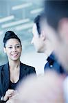 Young businesswoman sitting in a business meeting with colleagues