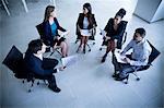 Business people sitting in a circle having a business meeting