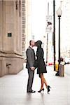 Full Length Portrait of Couple Kissing Outdoors on City Sidewalk, Toronto, Ontario, Canada