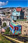 View of houses and colorful cable car on funicular railway, Valparaiso, Chile