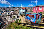 View of houses and colorful cable car on funicular railway, Valparaiso, Chile