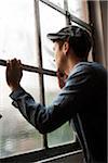 Portrait of Young Man Looking out Window, Mannheim, Baden-Wurttemberg, Germany