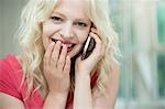 Young woman on cellphone, giggling