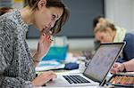 Woman using laptop in art class