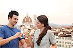 Couple toasting champagne, Florence Cathedral in background, Florence, Tuscany, Italy