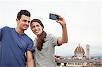 Couple photographing themselves with Florence Cathedral, Florence, Tuscany, Italy