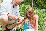 Grandfather and granddaughter gardening