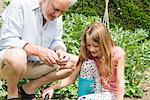 Grandfather and granddaughter gardening