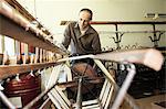 Worker using loom in wool factory