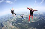 Three skydivers free falling above Leutkirch, Bavaria, Germany