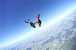 Female skydivers upside down above Leutkirch, Bavaria, Germany