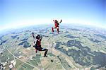 Skydivers having fun above Leutkirch, Bavaria, Germany