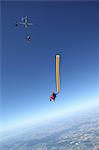 Skydivers free falling with air tube above Leutkirch, Bavaria, Germany