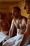 Close up of three men sitting in sauna