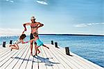 Father and daughters playing on pier, Utvalnas, Gavle, Sweden