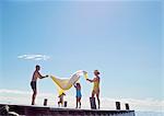 Young family having fun on pier, Utvalnas, Gavle, Sweden