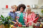 Friends preparing vegetables in kitchen