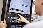 Worker checking computer monitor in engineering factory