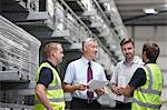 Warehouse workers and manager meeting in engineering warehouse