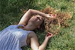 Teenage girl lying on grass, Prague, Czech Republic