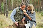 Mid adult couple foraging for mushrooms in forest