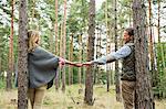Mid adult couple holding hands in forest