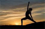 Silhouette of young woman doing yoga, Moab, Utah, USA