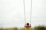 Female toddler on beach swing