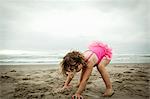 Female toddler playing with sand