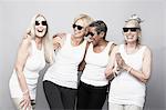 Studio portrait of senior women friends in sunglasses